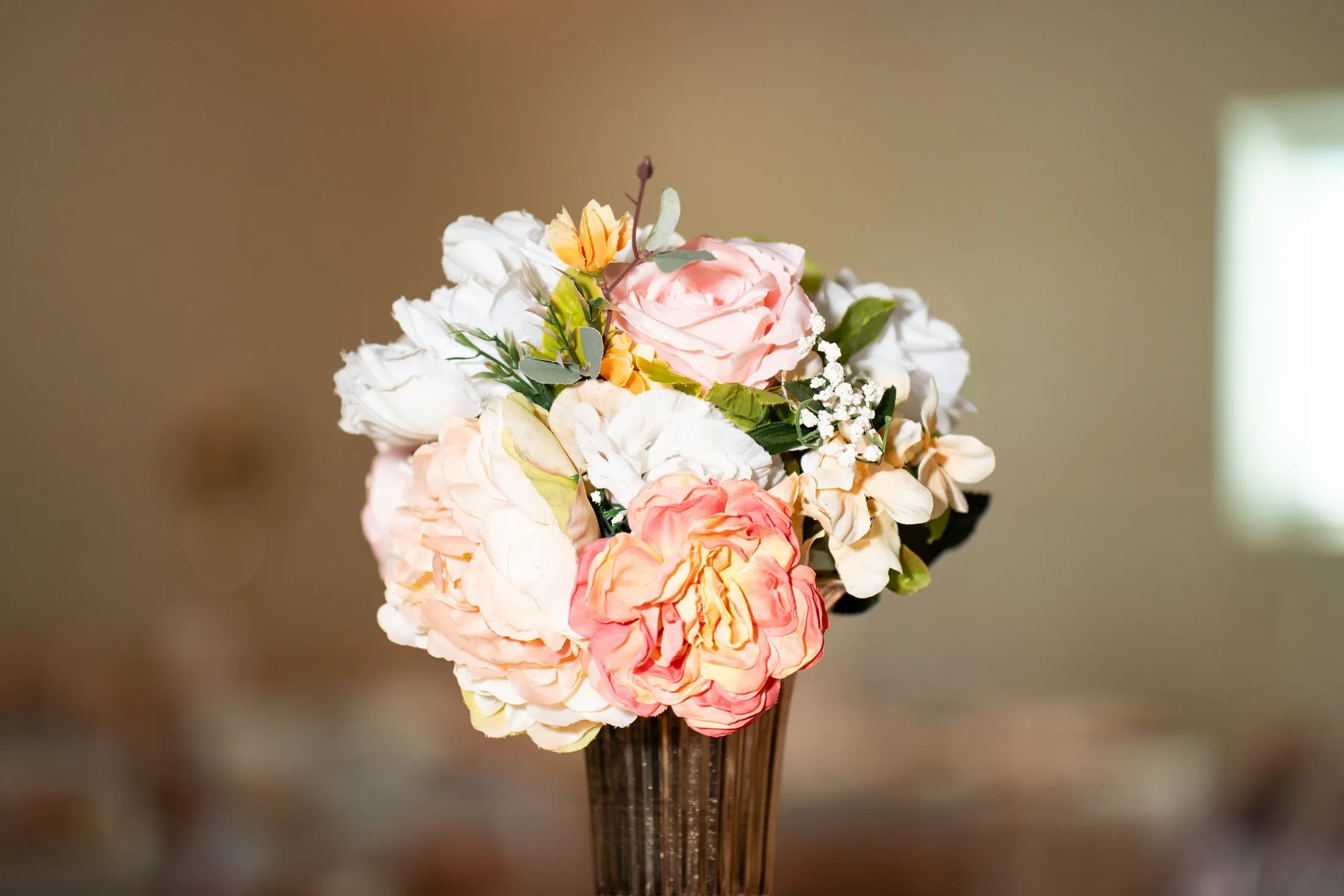 Blush and peach flower centerpiece at the quince reception at Hidden Acres Ranch in Hudson Oaks