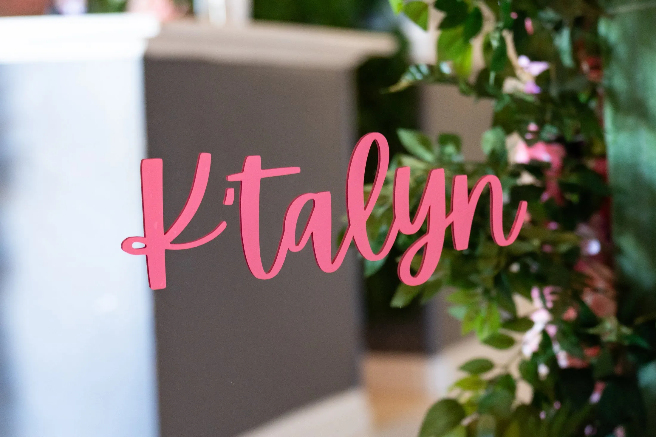 Custom pink name sign with greenery