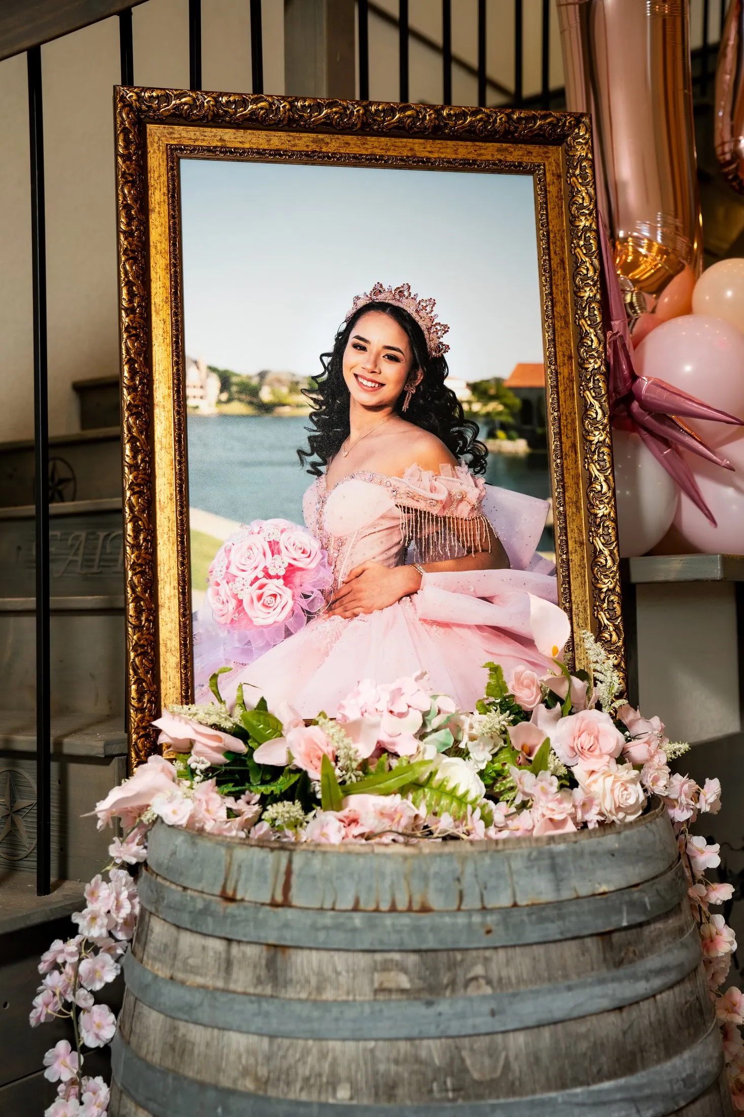 Framed portrait from her photoshoot displayed on a barrel to welcome guests at Hidden Acres Ranch in Hudson Oaks