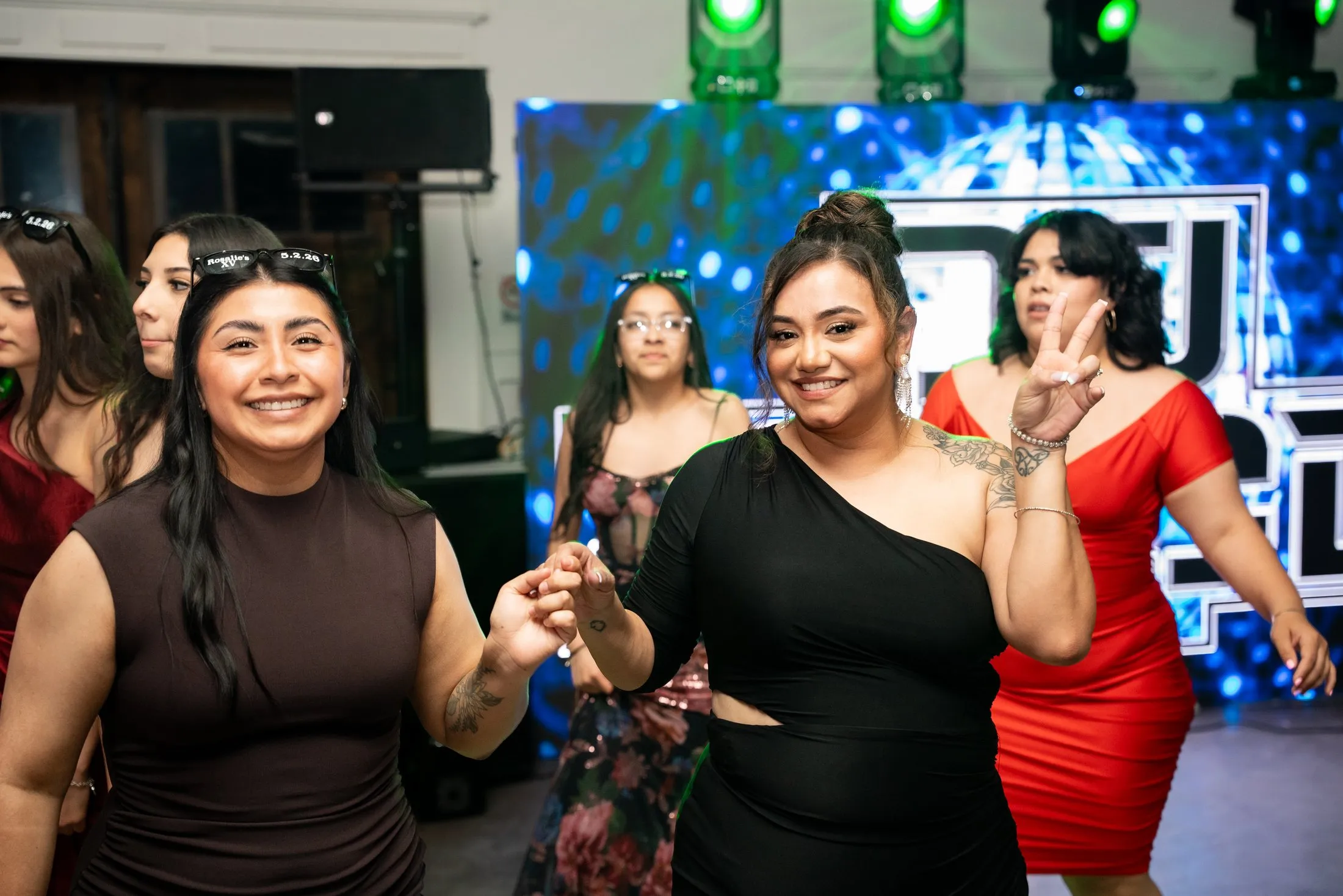 Friends smiling on the dance floor at Hidden Acres Ranch in Hudson Oaks