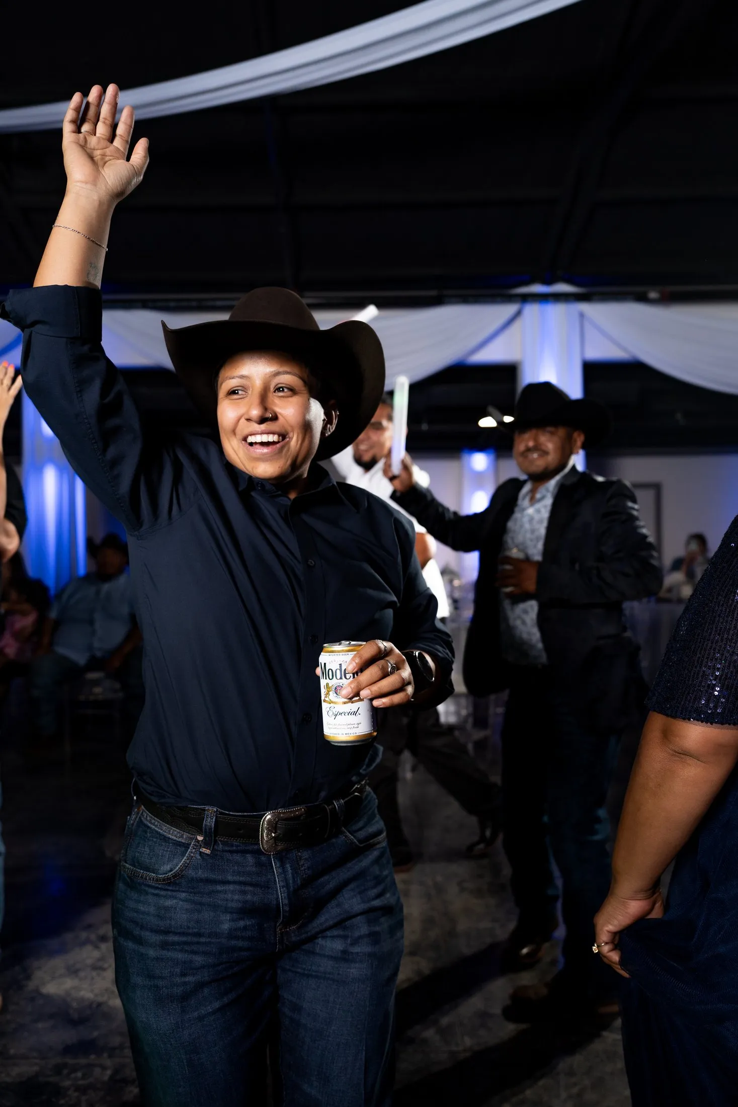 Guest in a cowboy hat dancing at the quince reception
