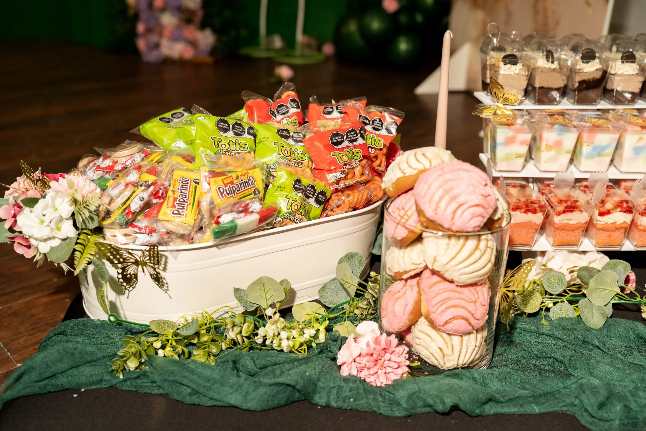 Mexican candy and pan dulce conchas on the dessert table