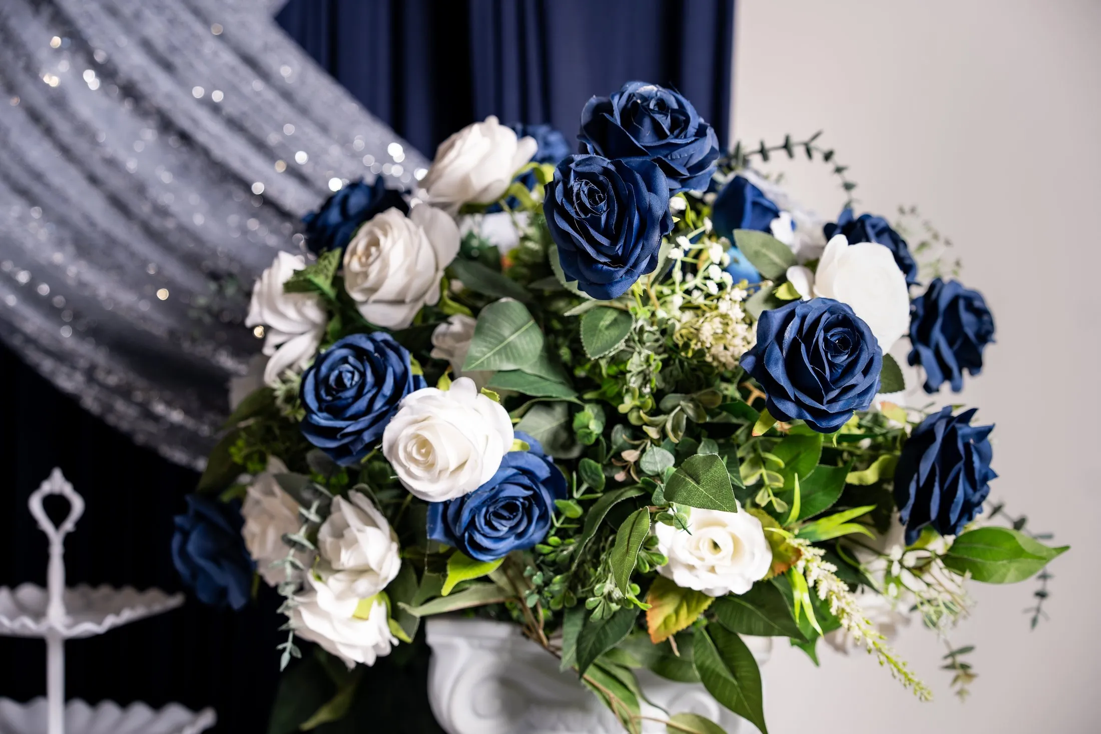 Navy and white rose centerpiece with silver sequin draping