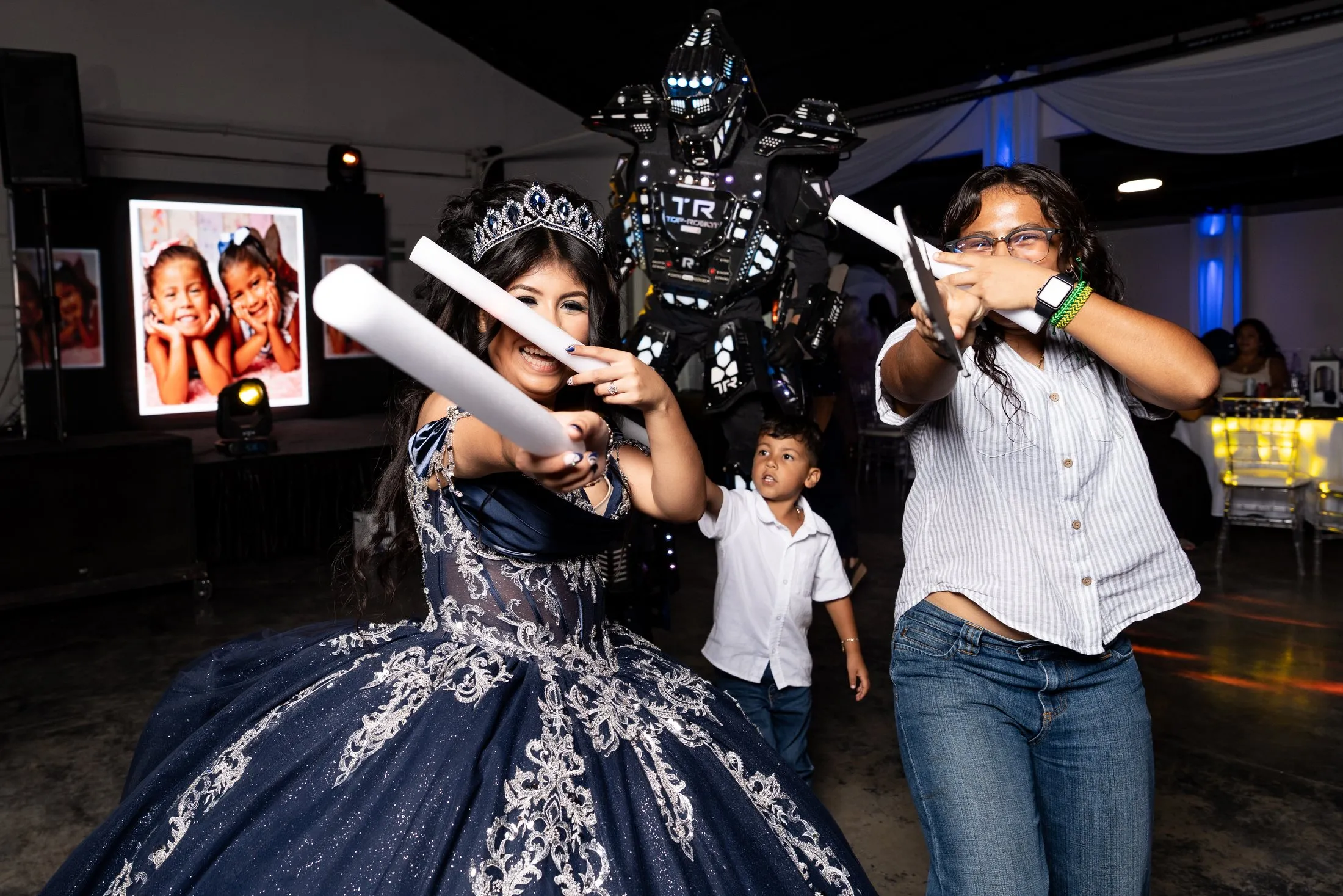 Quinceañera and guests on the open dance floor with foam sticks