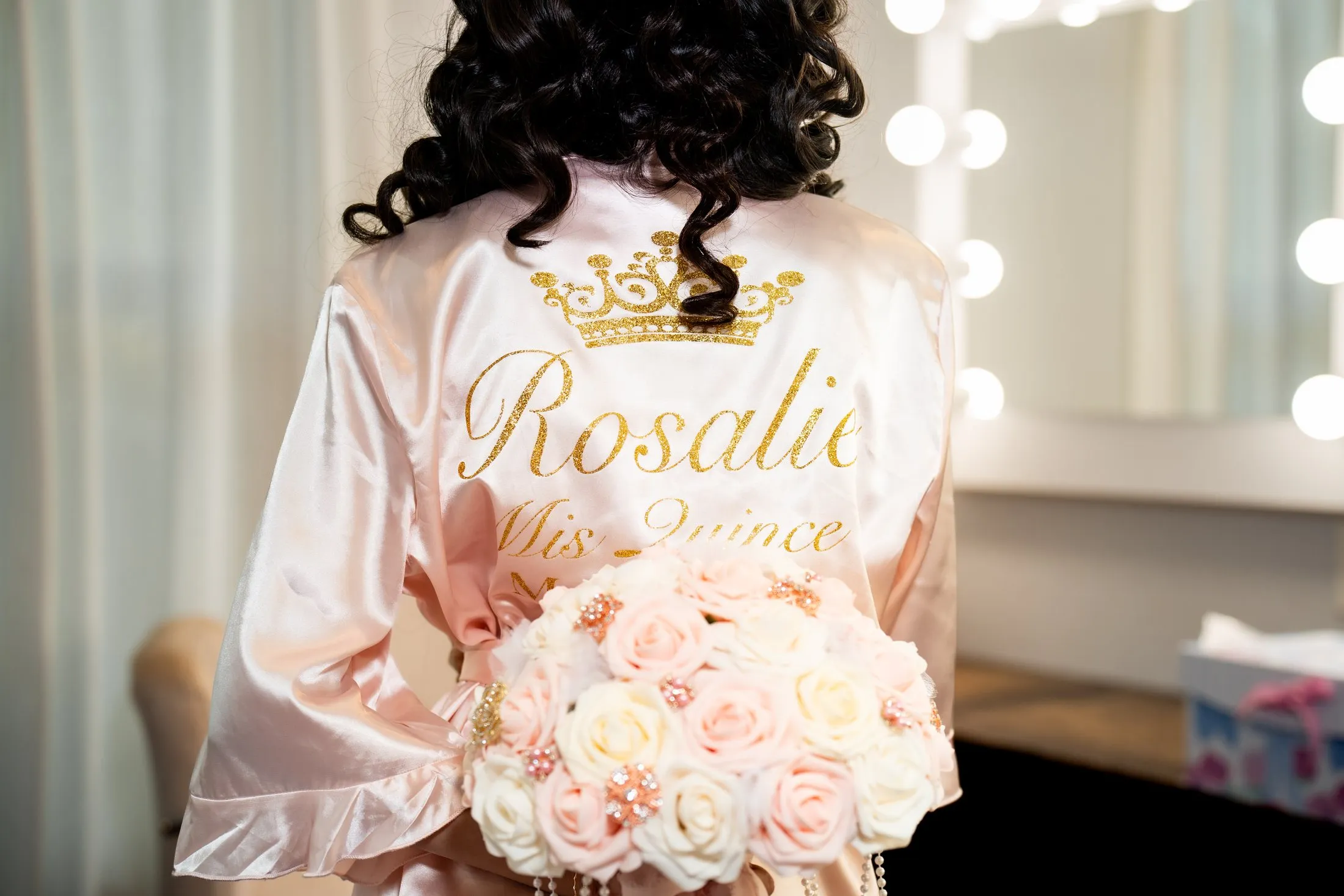 Personalized “Rosalie Mis Quince” robe and pink rose bouquet at Hidden Acres Ranch in Hudson Oaks