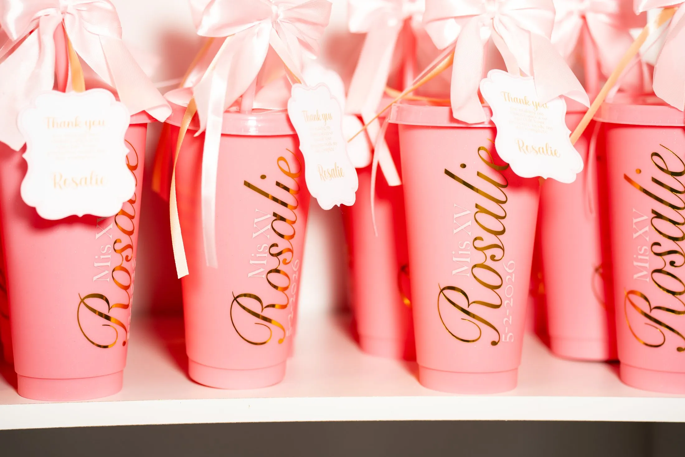 Personalized pink tumblers with her name as quince party favors at Hidden Acres Ranch in Hudson Oaks