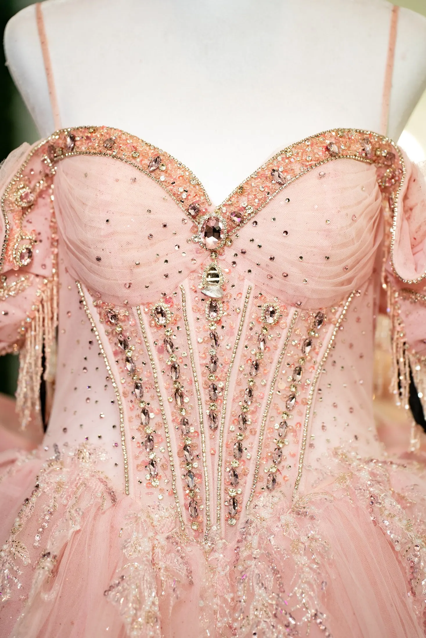 Crystal-embellished corset of the pink quinceañera dress on a mannequin at Hidden Acres Ranch in Hudson Oaks