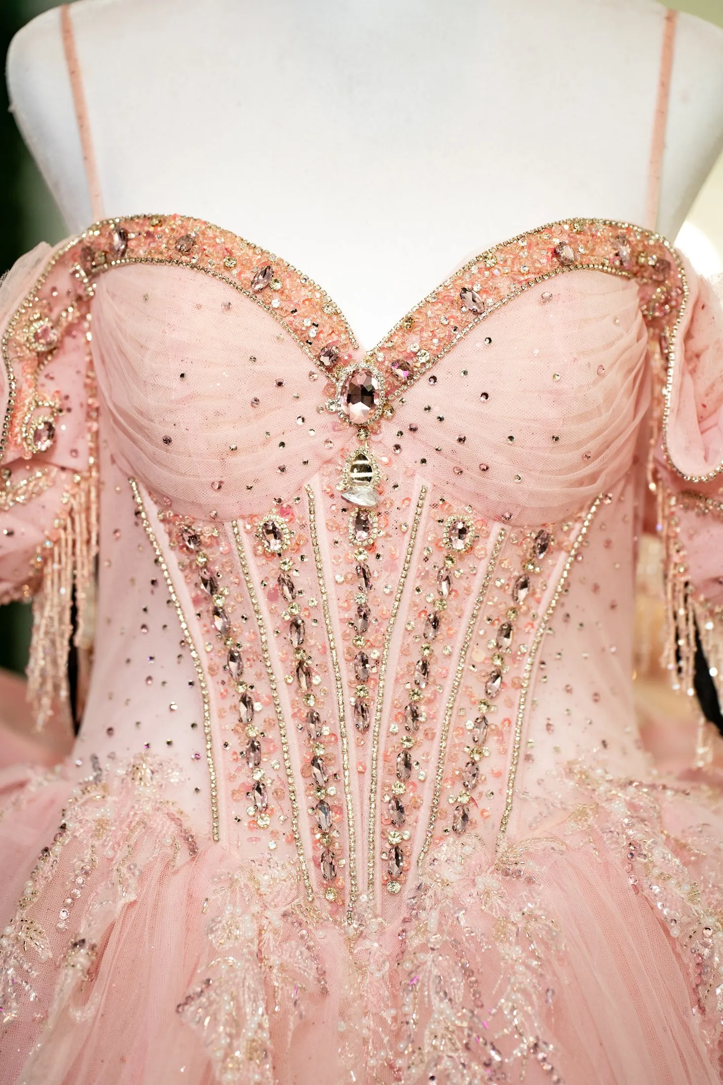 Crystal-embellished corset of the pink quinceañera dress on a mannequin at Hidden Acres Ranch in Hudson Oaks