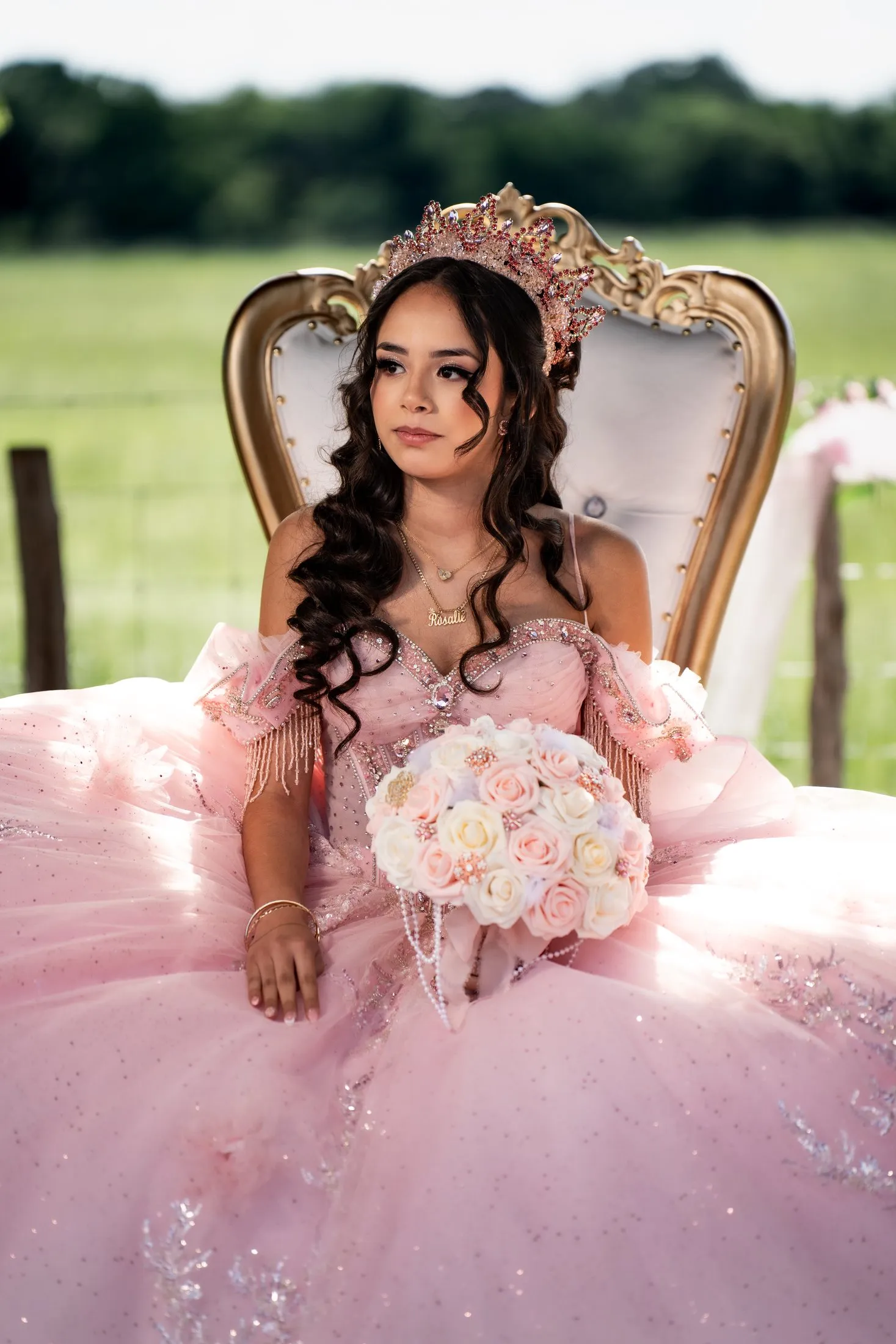 Rosalie on a gold throne in her pink gown during the outdoor blessing at Hidden Acres Ranch in Hudson Oaks