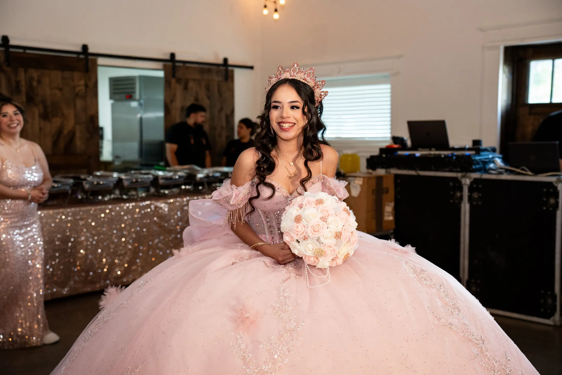 Quinceañera smiling during her grand entrance in a pink quince gown at Hidden Acres Ranch in Hudson Oaks