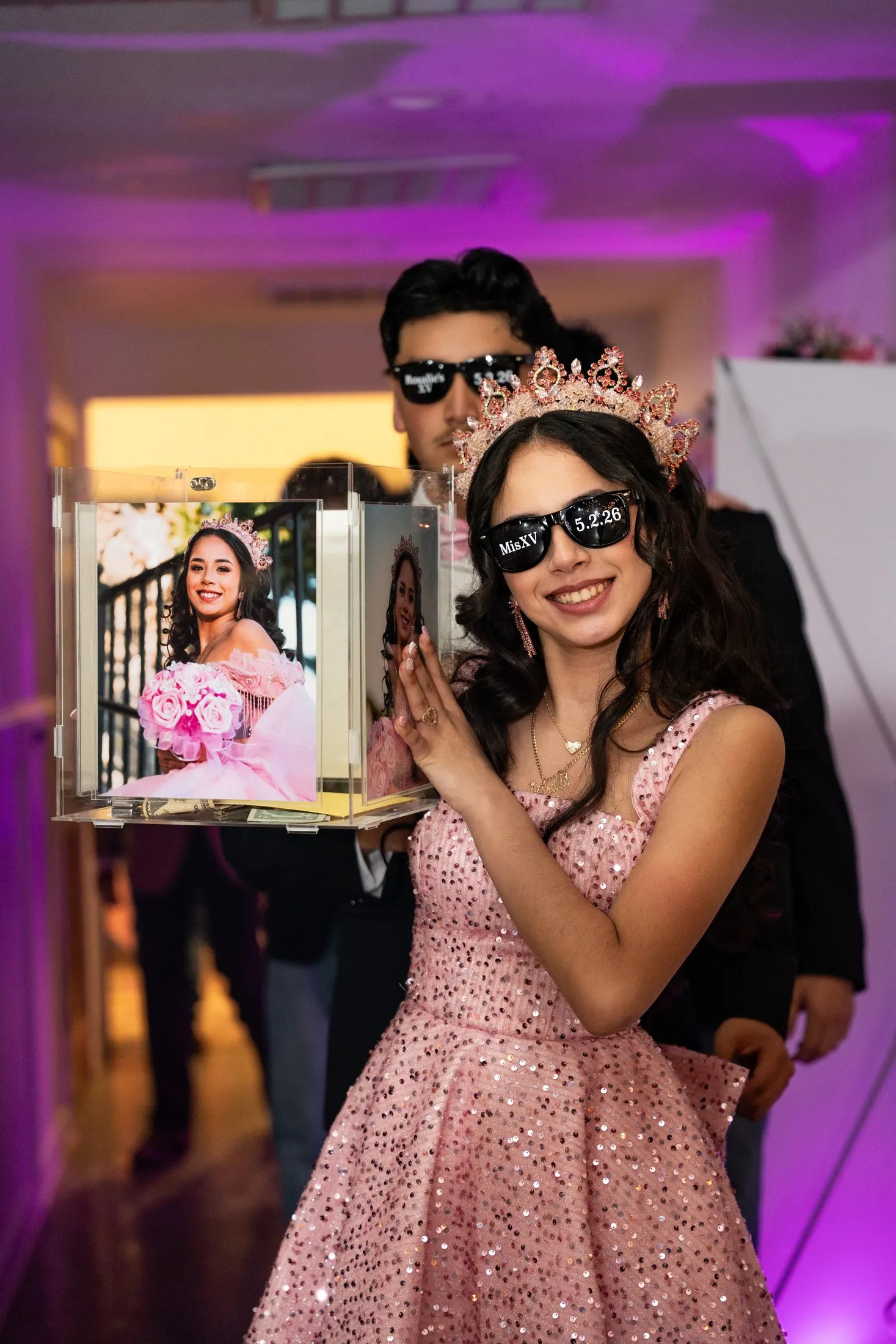 Quinceañera in a pink sequin party dress and sunglasses at the photo booth at Hidden Acres Ranch in Hudson Oaks