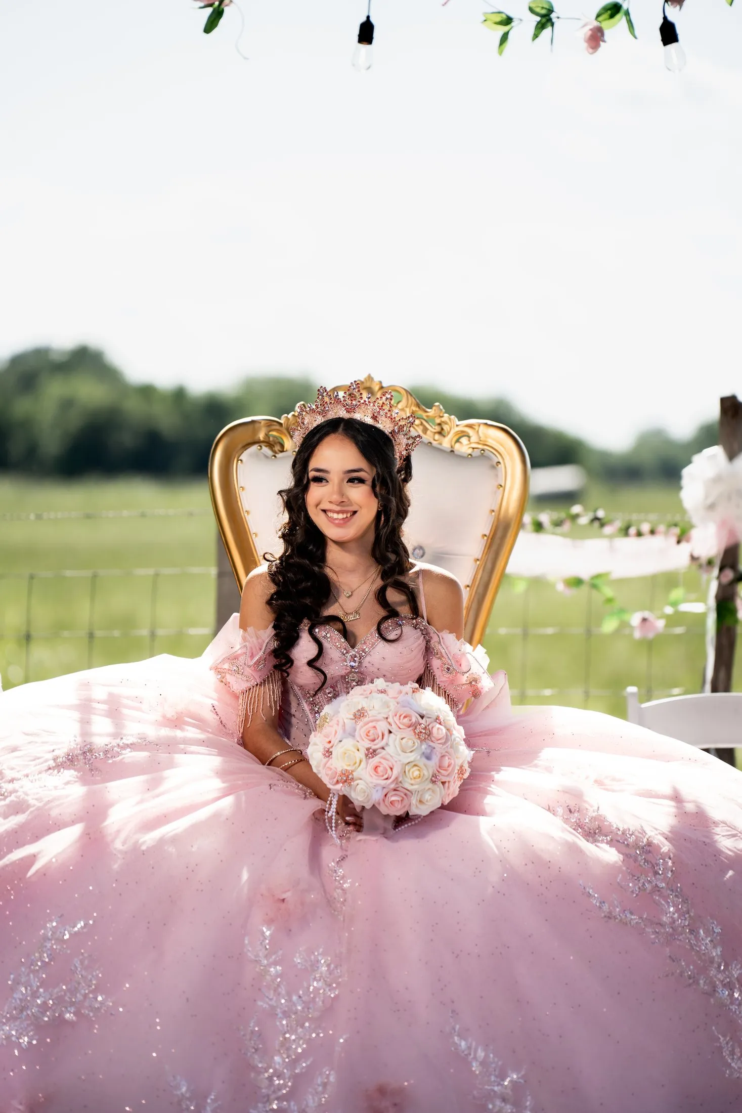 Smiling quinceañera on her gold throne at the ranch blessing at Hidden Acres Ranch in Hudson Oaks