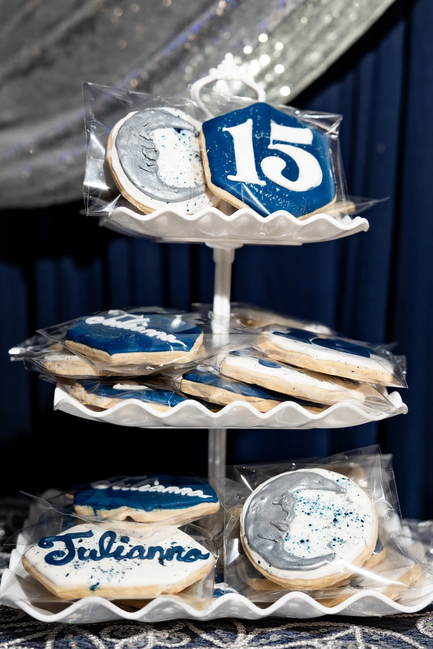 Tiered stand of navy and silver quince cookies